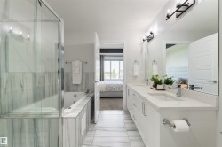 Dual vanity with white cabinetry and integrated sinks - 