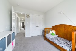 Light grey wall paint with a contrasting white trim, grey carpeting, and a white interior door - 