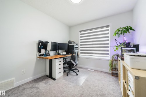 Recessed lighting, light gray wall paint, and gray carpeting - 1032 Berg Place, Leduc, AB 