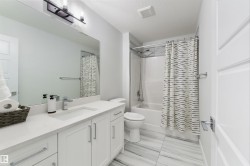 White shaker-style vanity with a light-toned countertop, rectangular undermount sink, and chrome faucet - 