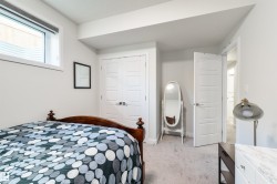 Window with privacy blinds, light gray carpet, white interior doors, and a built-in closet with panel doors - 