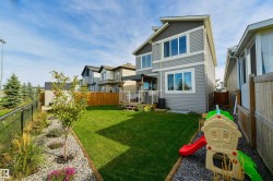 Two-story contemporary residence with light gray siding and dark gray upper-level siding - 