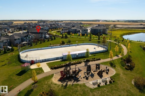 Neighborhood featuring a recreational ice rink, playground, and walking paths - 1032 Berg Place, Leduc, AB 