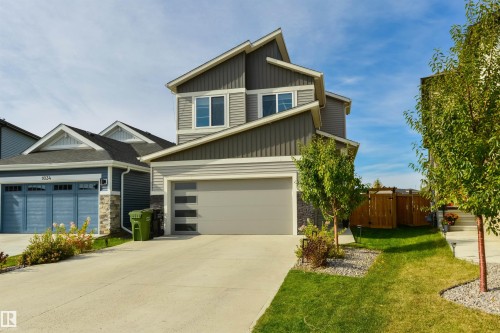 Contemporary exterior with varied siding textures, a multi-pane garage door, and a concrete driveway - 1032 Berg Place, Leduc, AB 