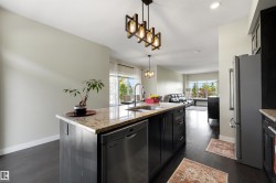 Kitchen island with integrated stainless steel dishwasher, undermount sink, and granite countertop - 
