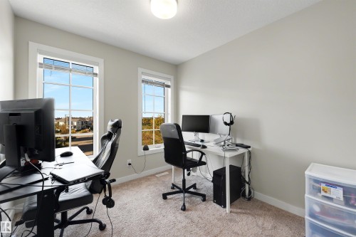 Light-colored walls, two windows with horizontal blinds, and carpeted flooring - #1 1636 Kerr Rd Nw, Edmonton, AB 