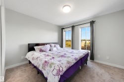 Carpeted room with light gray walls, two windows with white trim, and a flush mount ceiling light - 