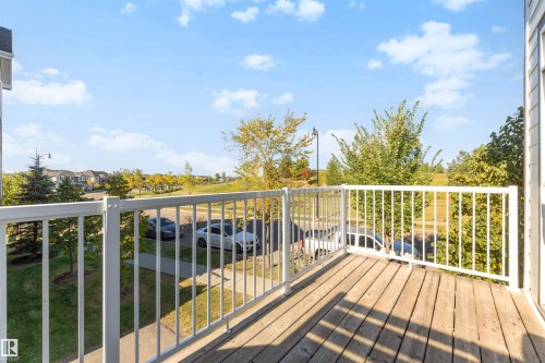 Balcony with wood-finish decking and white railing - #1 1636 Kerr Rd Nw, Edmonton, AB 
