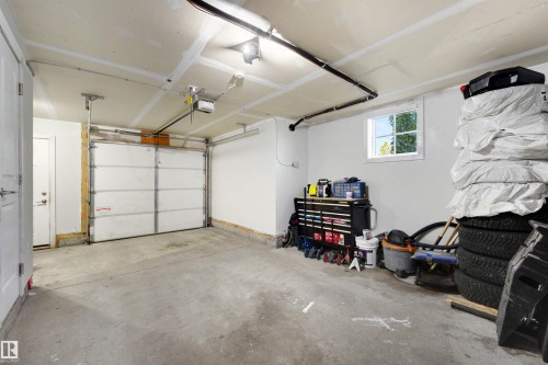 Interior garage with a concrete floor, white walls, and a single window - #1 1636 Kerr Rd Nw, Edmonton, AB 