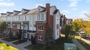 Multi-level townhome architecture featuring brick and siding exteriors, dormer windows, and a gabled roofline - #1 1636 Kerr Rd Nw, Edmonton, AB 