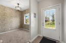 Recessed ceiling light fixture, accent wall with textured wallpaper, carpeted flooring, and a window with blinds - #1 1636 Kerr Rd Nw, Edmonton, AB 
