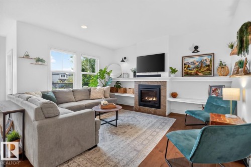 Recessed lighting illuminates the living area with wood-finish flooring - 21 Altadena Point(E), Sherwood Park, AB 
