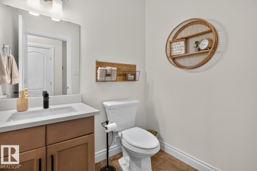 Vanity with integrated sink, wood-finish cabinetry, and contemporary fixtures - 21 Altadena Point(E), Sherwood Park, AB 