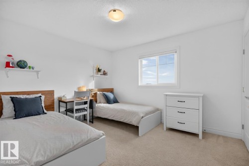 Carpeted flooring, white walls, built-in shelving, white window trim, and a flush mount ceiling light - 21 Altadena Point(E), Sherwood Park, AB 