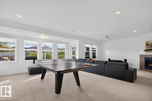Expansive room featuring recessed lighting, a built-in fireplace with a tile surround, and multiple windows - 21 Altadena Point(E), Sherwood Park, AB 