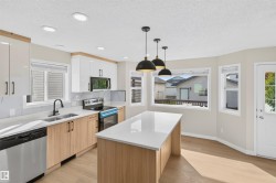 Kitchen featuring a central island, recessed lighting, and wood-finish flooring - 