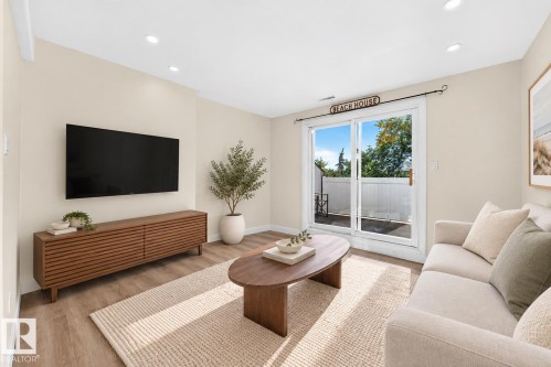 Recessed lighting, wood-finish flooring, sliding glass door, and neutral wall tones - 161 Lancaster Terrace Nw, Edmonton, AB 