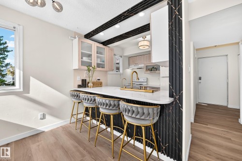 Kitchen pass-through with a white countertop and gold-tone faucet - 161 Lancaster Terrace Nw, Edmonton, AB 