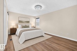 Wood-finish flooring, neutral wall tones, and a crystal semi-flush mount light fixture - 