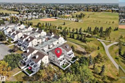 Townhouse community featuring private balconies, individual patios, and direct access to expansive green spaces with paved pathways - 