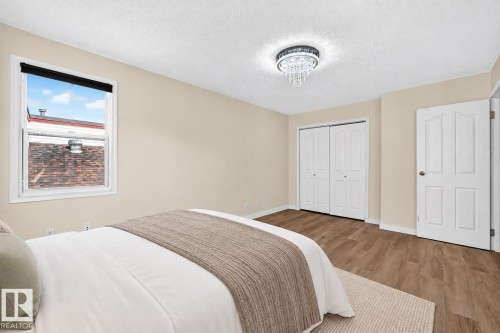 Neutral wall tones, wood-finish flooring, and a crystal chandelier - 161 Lancaster Terrace Nw, Edmonton, AB 