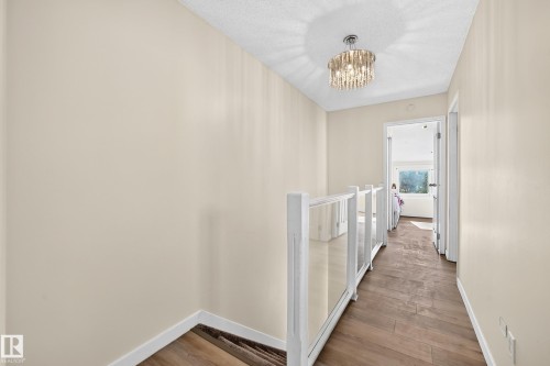 Wood-finish flooring throughout, paired with light-toned wall finishes - 161 Lancaster Terrace Nw, Edmonton, AB 