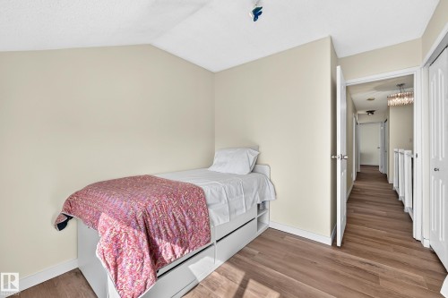 Wood-finish flooring with neutral wall paint and white trim - 161 Lancaster Terrace Nw, Edmonton, AB 