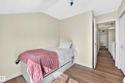 Wood-finish flooring with neutral wall paint and white trim - 