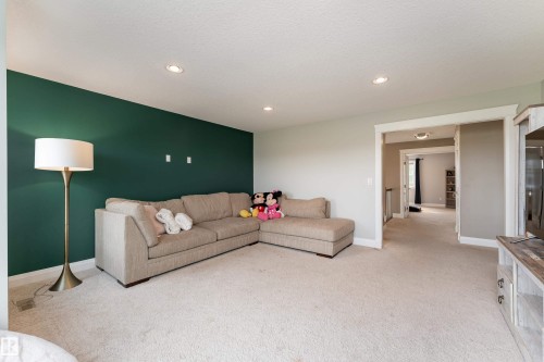 Recessed lighting, light-toned carpeting, painted accent wall, and a wide entryway - 6613 31 Avenue, Beaumont, AB 