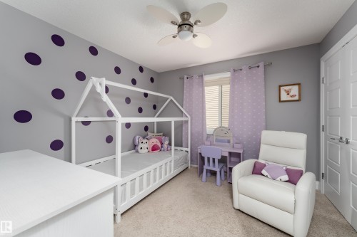 Ceiling fan with integrated lighting, wall-to-wall carpeting, light-colored walls, and window with blinds - 6613 31 Avenue, Beaumont, AB 