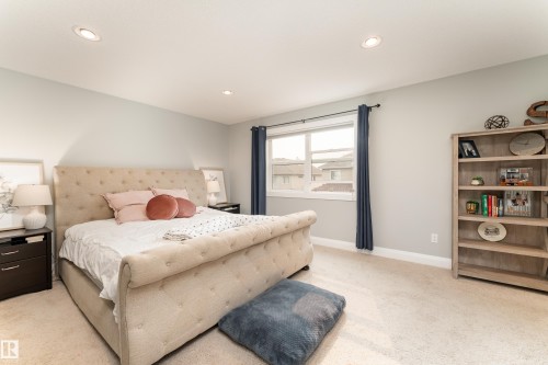 Recessed ceiling lighting, light neutral-toned walls, and carpet flooring create a bright atmosphere - 6613 31 Avenue, Beaumont, AB 