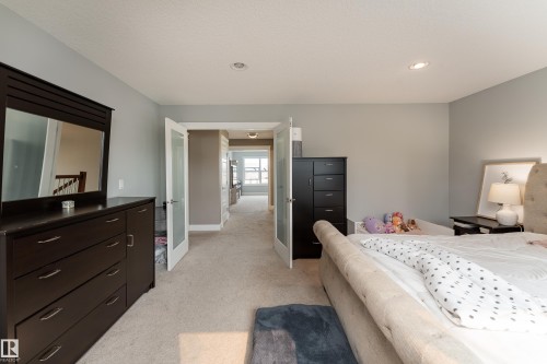 Recessed lighting illuminates neutral carpeting and light gray walls - 6613 31 Avenue, Beaumont, AB 