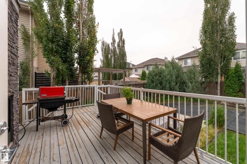 Spacious outdoor deck with a white railing, providing direct access to the back exterior - 6613 31 Avenue, Beaumont, AB 