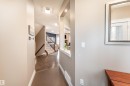 Tile flooring, integrated lighting, wood-finish flooring, staircase with carpeted treads, and a built-in wall niche - 6613 31 Avenue, Beaumont, AB 