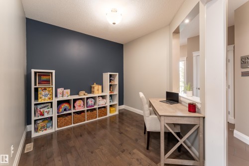 Wood-finish flooring with a contrasting accent wall - 6613 31 Avenue, Beaumont, AB 