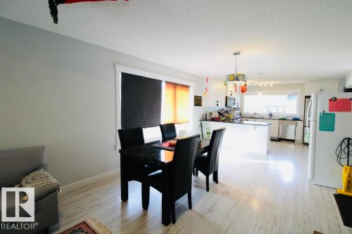Open-concept living space featuring light wood-finish flooring - 17440 77 Street Nw, Edmonton, AB 