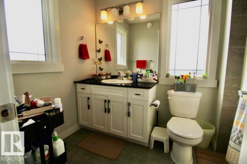 White vanity with black countertop and undermount sink - 17440 77 Street Nw, Edmonton, AB 