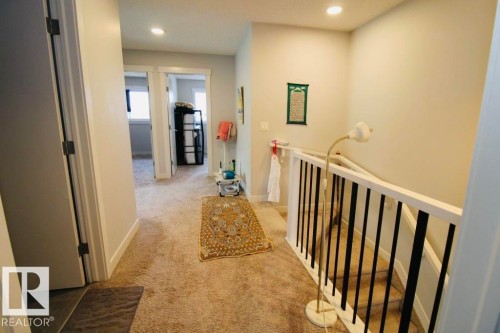 Carpeted hallway with recessed lighting and white trim - 17440 77 Street Nw, Edmonton, AB 