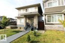 Two-story exterior with light-colored siding and dark horizontal accents - 17440 77 Street Nw, Edmonton, AB 