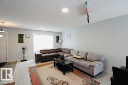 Recessed ceiling lighting, white wood-finish flooring, and a window with white trim - 