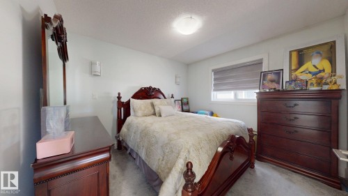 Recessed ceiling light fixture, window with horizontal blinds, light-toned walls, and wood-finish flooring - 1103 30 Street Nw, Edmonton, AB 