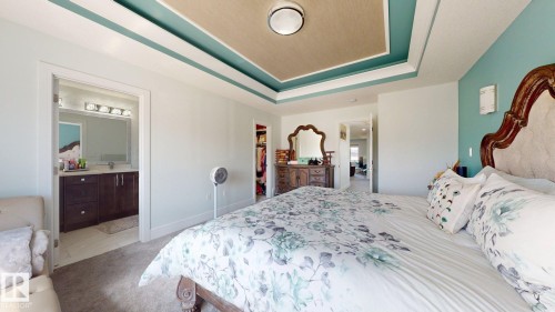 Recessed tray ceiling with accent color, light-colored walls, and carpet flooring - 1103 30 Street Nw, Edmonton, AB 