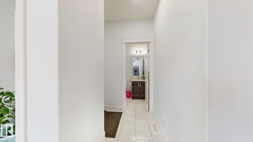 Hallway with light-toned walls and tile flooring - 1103 30 Street Nw, Edmonton, AB 