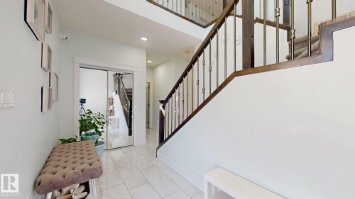Staircase with wood railing and metal balusters - 1103 30 Street Nw, Edmonton, AB 
