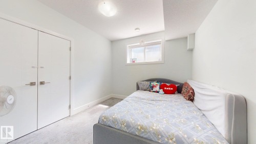 Wall-to-wall carpeting and white walls with an overhead light fixture - 1103 30 Street Nw, Edmonton, AB 