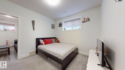 Light-colored carpeting, white walls, and a window with blinds provide natural light - 1103 30 Street Nw, Edmonton, AB 