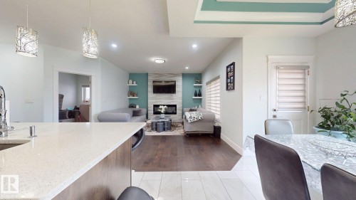 Kitchen island with a light-toned countertop, sink, and pendant lighting - 1103 30 Street Nw, Edmonton, AB 
