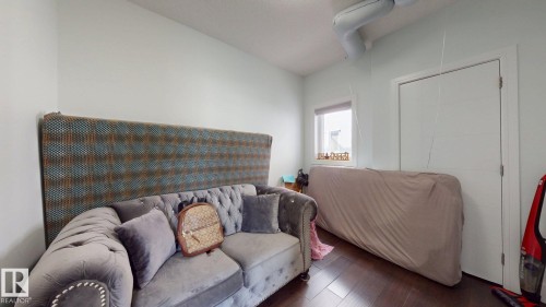 Dark wood-finish flooring with a single window - 1103 30 Street Nw, Edmonton, AB 