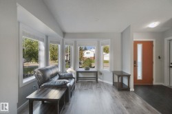 Bay window with multiple panes, wood-finish flooring, recessed lighting, and a front entry door with vertical glass insert - 