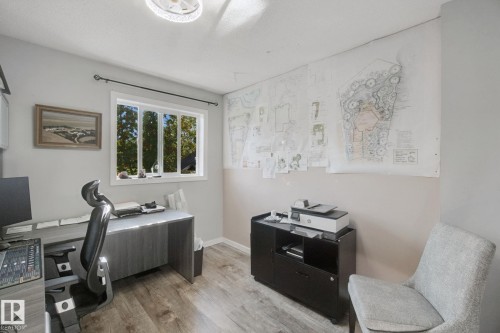Wood-finish flooring, white trim window, neutral wall paint, and overhead lighting - 38 Menalta Place, Cardiff, AB 